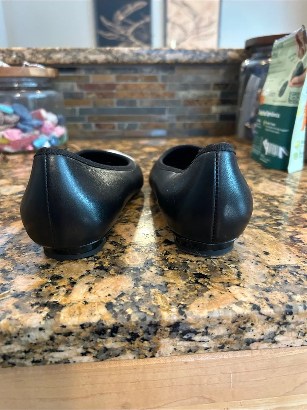 CHANEL Black Leather Flats with White Pointed Toe and CC Stitching